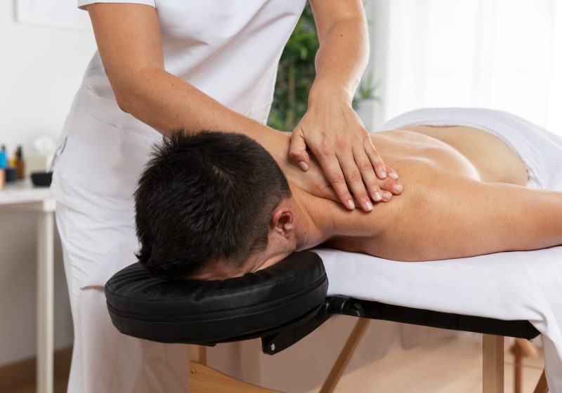 physiotherapist-massaging-patient-office