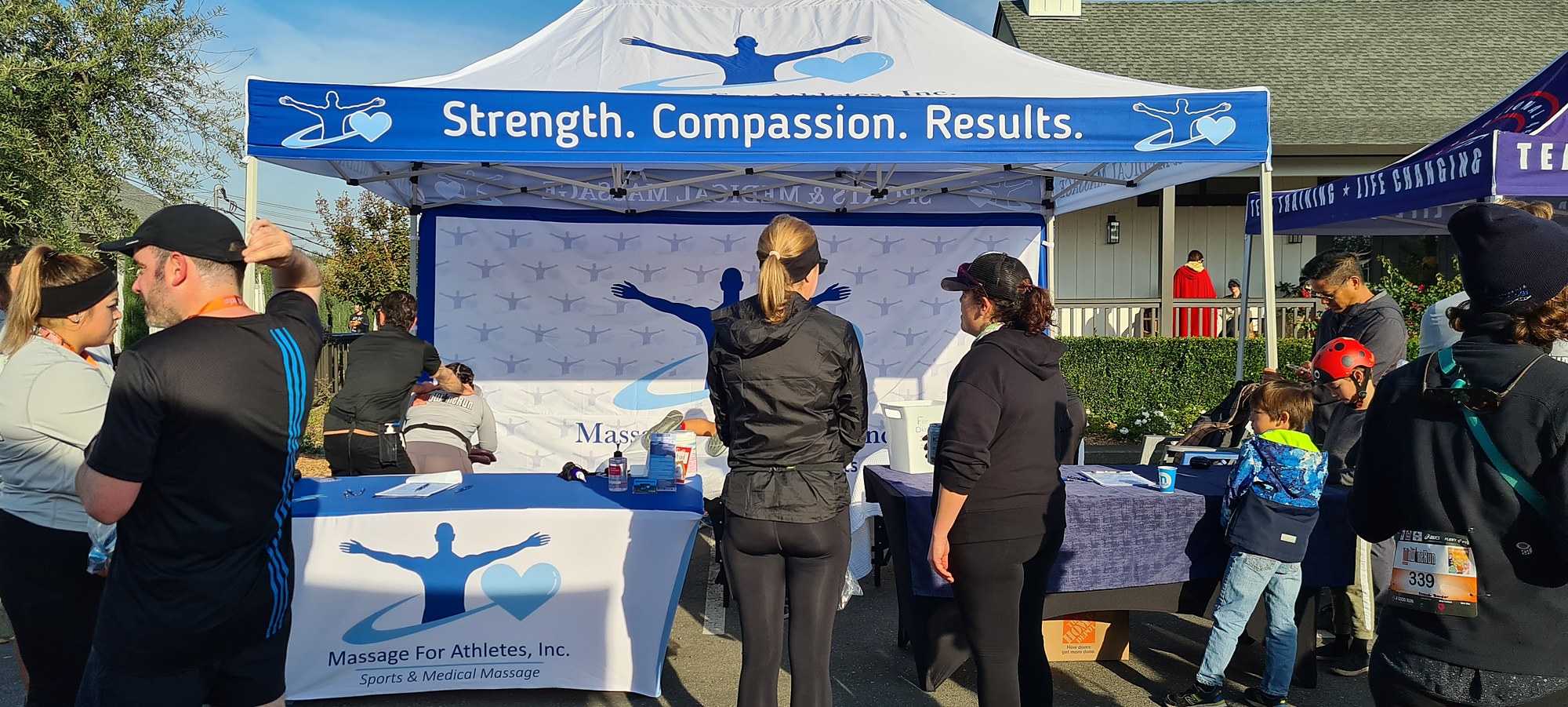 Massage For Athletes event tent with the Strength. Compassion. Results. banner