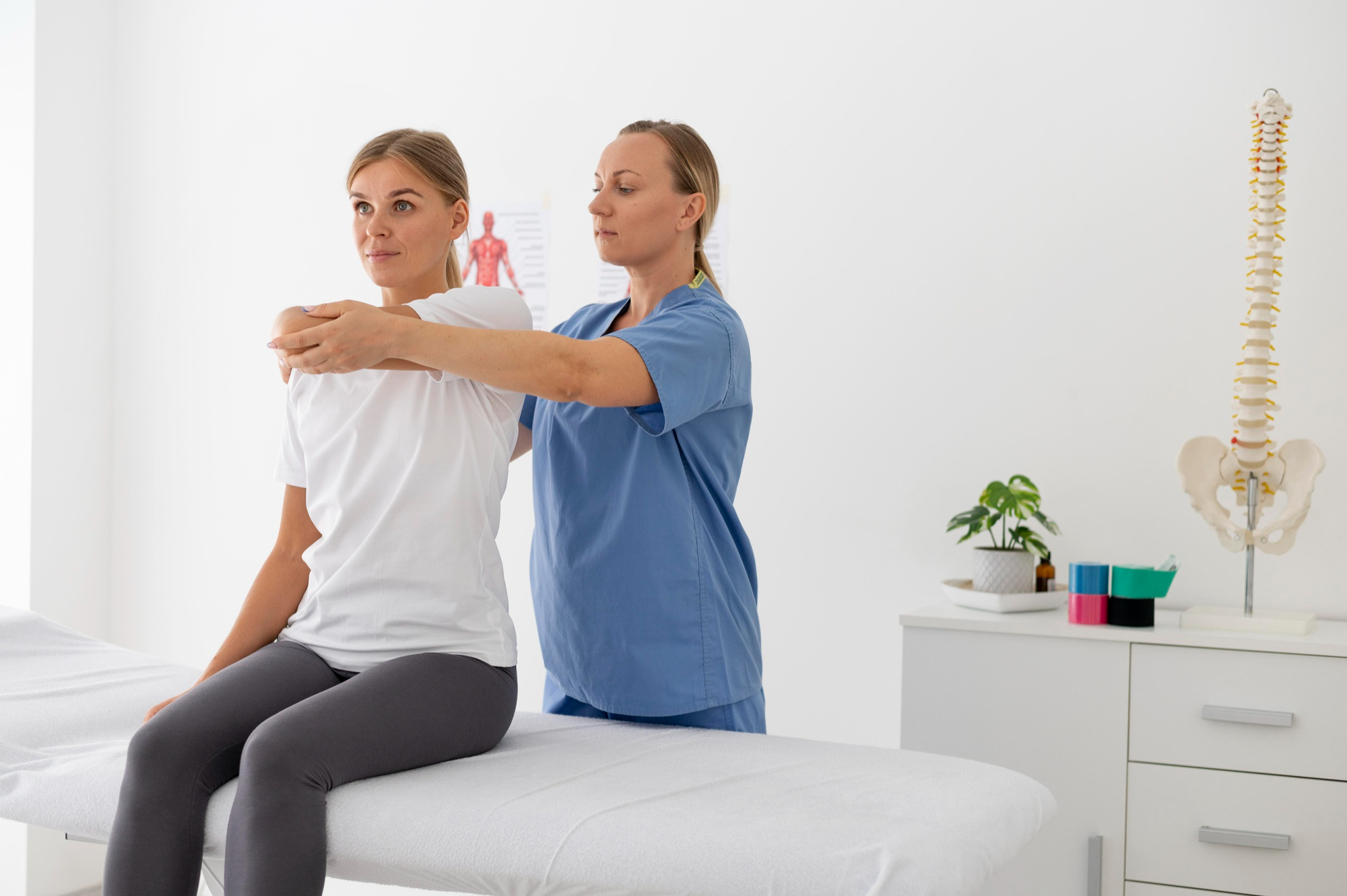 physiotherapist-helping-female-patient-her-clinic